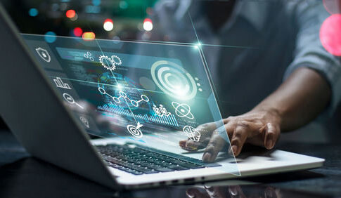Person using laptop with futuristic data and analytics interface