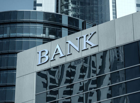 Bank building facade with large sign and glass windows