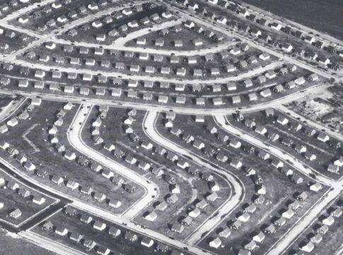 Aerial view of a suburban neighborhood featuring winding streets and rows of houses