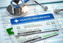 Phantom Obamacare: Was Your Name Used? Stethoscope and health insurance cards on medical chart.