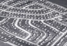 County System Hijacked—Homes Vanish Aerial view of a suburban neighborhood featuring winding streets and rows of houses