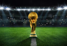 World Cup Chaos: Titans All Collide Golden trophy on soccer field under stadium lights
