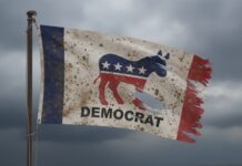 A weathered flag featuring the Democratic Party symbol and the word 'DEMOCRAT'